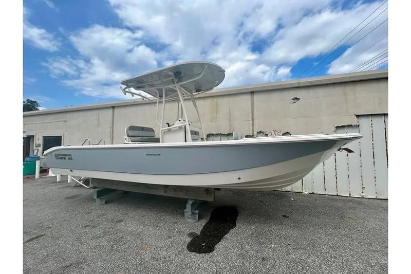 The Image of 2026 Carolina Skiff 24 Ultra Elite boat on display outdoors, under a partly cloudy sky. - 1
