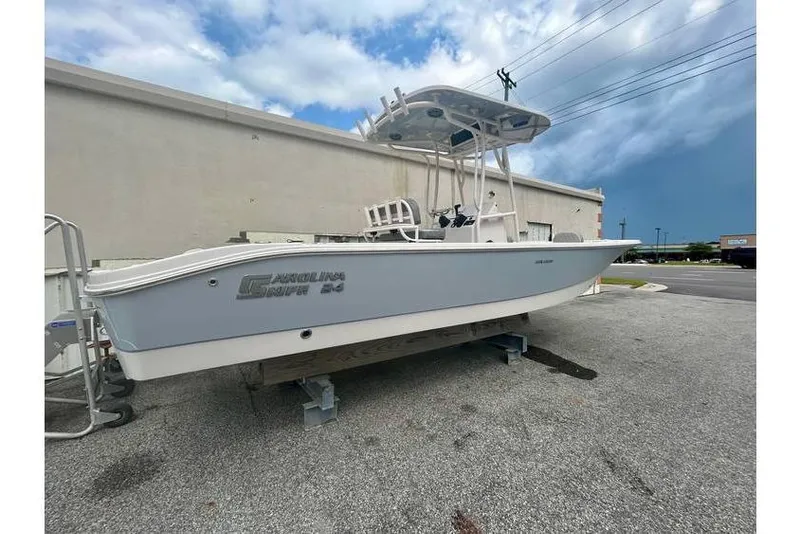 Slide: The Image of 2026 Carolina Skiff 24 Ultra Elite boat on display outdoors. - 7