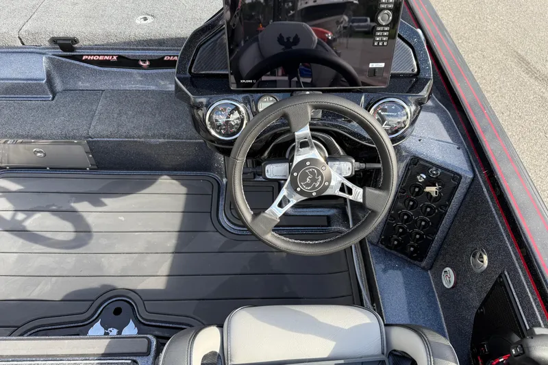Slide: The Image of 2026 Phoenix 921 Elite X II boat interior with advanced dashboard and spacious deck. - 18