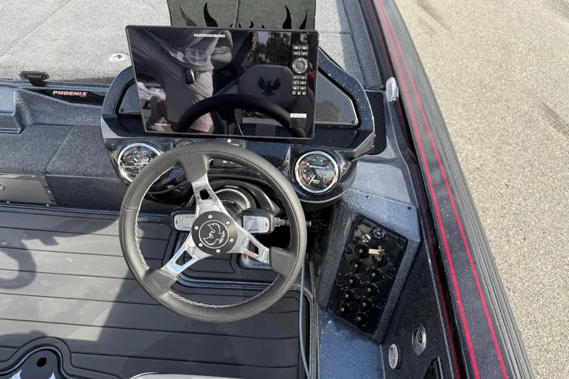 Slide: The Image of Interior of 2026 Phoenix 921 Elite X II boat with modern dashboard and seating. - 21