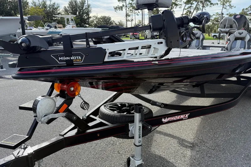 Slide: The Image of 2026 Phoenix 921 Elite X II boat with red detailing on a sleek black finish. - 5