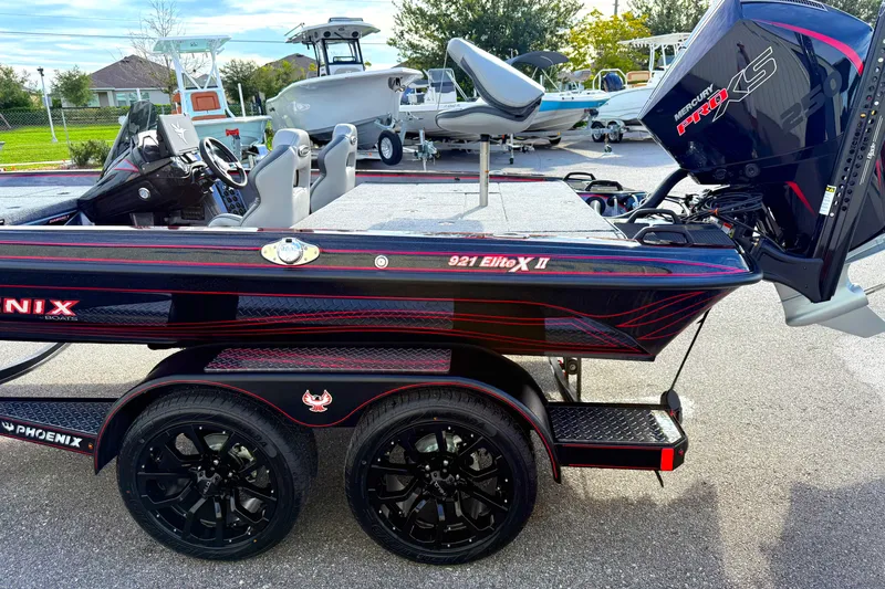 Slide: The Image of 2026 Phoenix 921 Elite X II boat with sleek black and red design on trailer. - 7