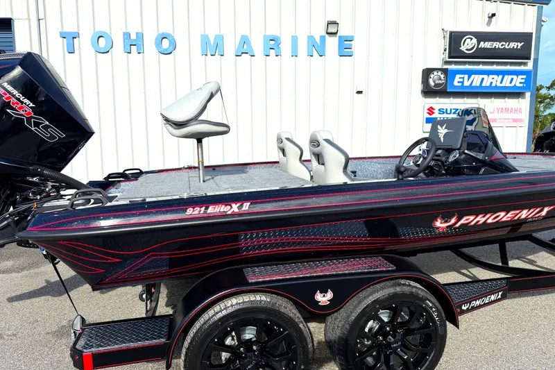 Slide: The Image of 2026 Phoenix 921 Elite X II boat with sleek black and red design on trailer. - 8