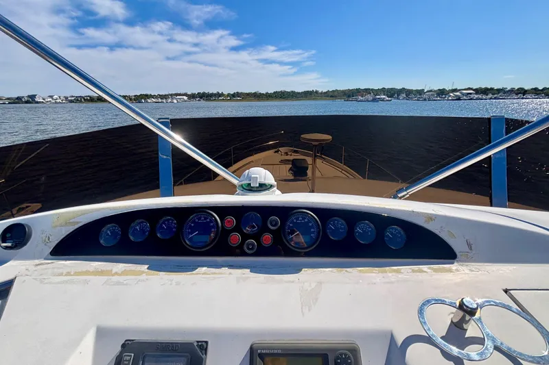 Slide: The Image of 2004 Viking Princess 61 Fly Bridge yacht dashboard with scenic water view. - 12