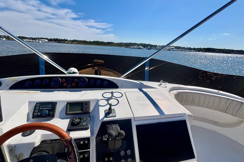 Slide: The Image of 2004 Viking Princess 61 Fly Bridge yacht helm with scenic water view. - 13