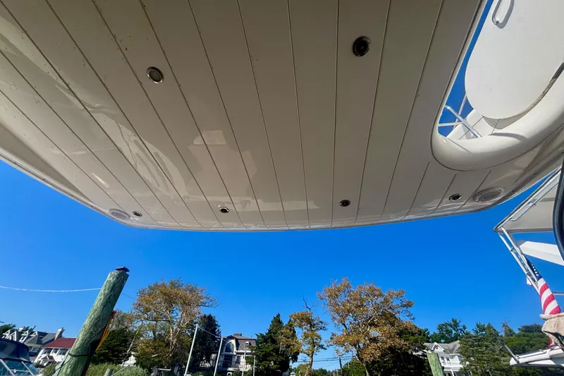 Slide: The Image of 2004 Viking Princess 61 Fly Bridge yacht underside against clear blue sky. - 20
