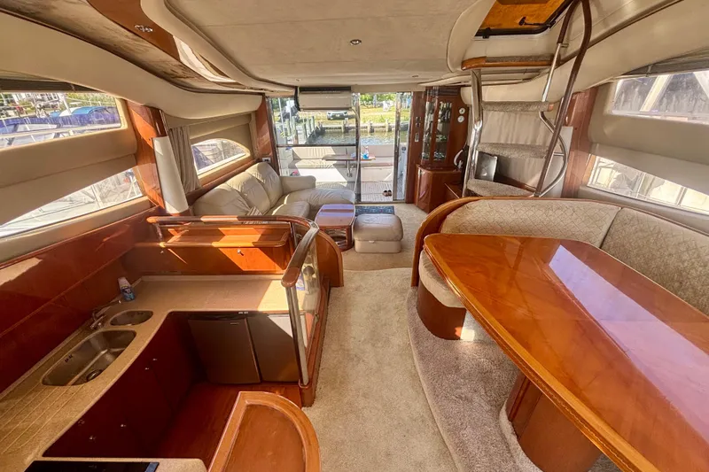 Slide: The Image of Luxurious interior of 2004 Viking Princess 61 Fly Bridge yacht with elegant wood finishes. - 23