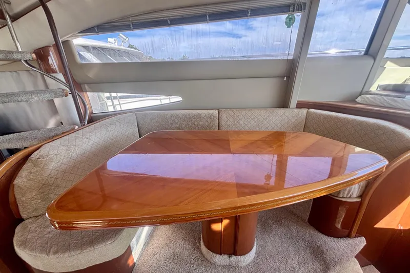 Slide: The Image of Luxurious interior of 2004 Viking Princess 61 Fly Bridge yacht with elegant wooden table. - 27