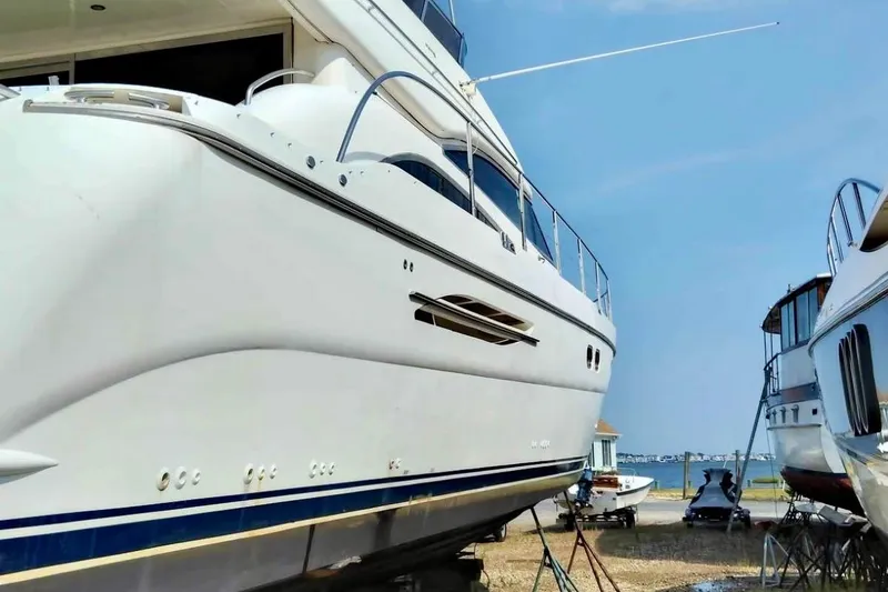 Slide: The Image of 2004 Viking Princess 61 Fly Bridge yacht on dry dock, side view. - 3