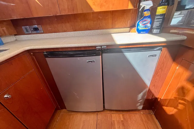Slide: The Image of Kitchen area of 2004 Viking Princess 61 Fly Bridge with dual mini fridges. - 30
