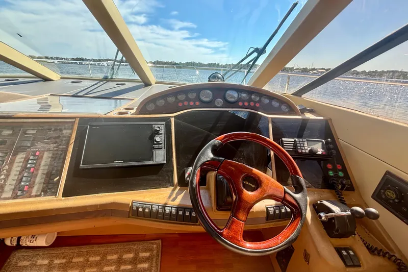Slide: The Image of Cockpit view of 2004 Viking Princess 61 Fly Bridge yacht with steering wheel and controls. - 32