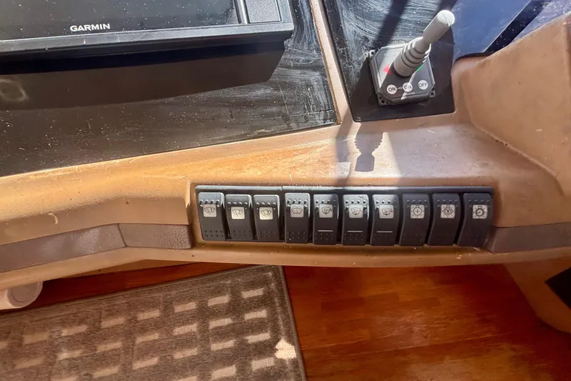 Slide: The Image of Control panel of 2004 Viking Princess 61 Fly Bridge with switches and Garmin display. - 35