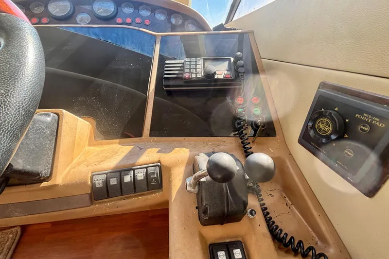 Slide: The Image of Control panel of a 2004 Viking Princess 61 Fly Bridge yacht, featuring navigation and communication equipment. - 38