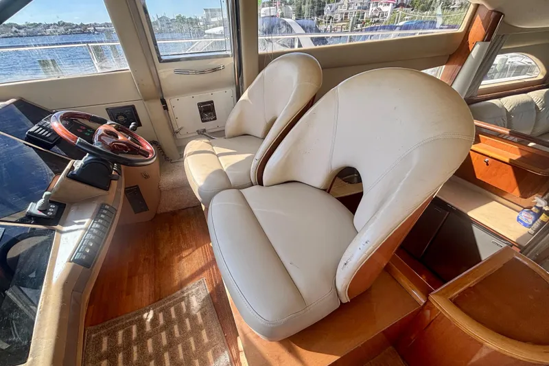 Slide: The Image of Interior of 2004 Viking Princess 61 Fly Bridge with leather seats and steering wheel. - 40