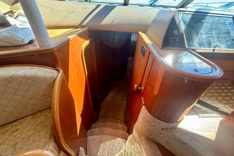 Slide: The Image of Interior of 2004 Viking Princess 61 Fly Bridge yacht with wooden cabinetry and carpeted stairs. - 41