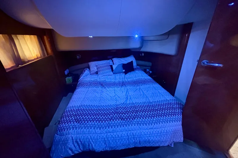 Slide: The Image of Cozy bedroom interior of 2004 Viking Princess 61 Fly Bridge yacht with ambient lighting. - 49