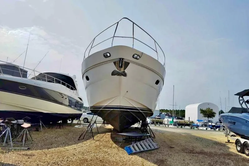 Slide: The Image of 2004 Viking Princess 61 Fly Bridge yacht on dry dock, surrounded by other boats. - 5