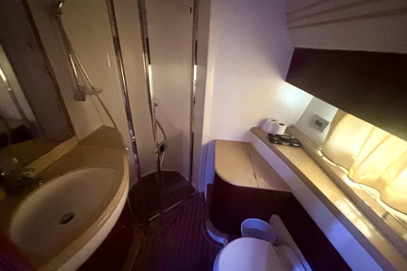 Slide: The Image of Bathroom interior of 2004 Viking Princess 61 Fly Bridge yacht, featuring sink and shower. - 51