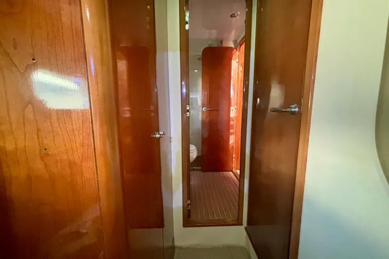 Slide: The Image of Interior hallway of 2004 Viking Princess 61 Fly Bridge yacht with wooden doors. - 57