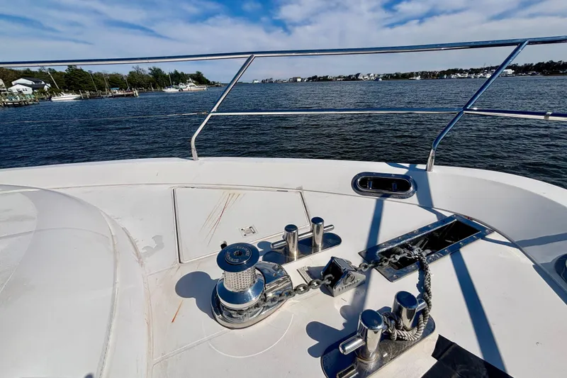 Slide: The Image of Bow view of 2004 Viking Princess 61 Fly Bridge yacht on calm waters. - 7