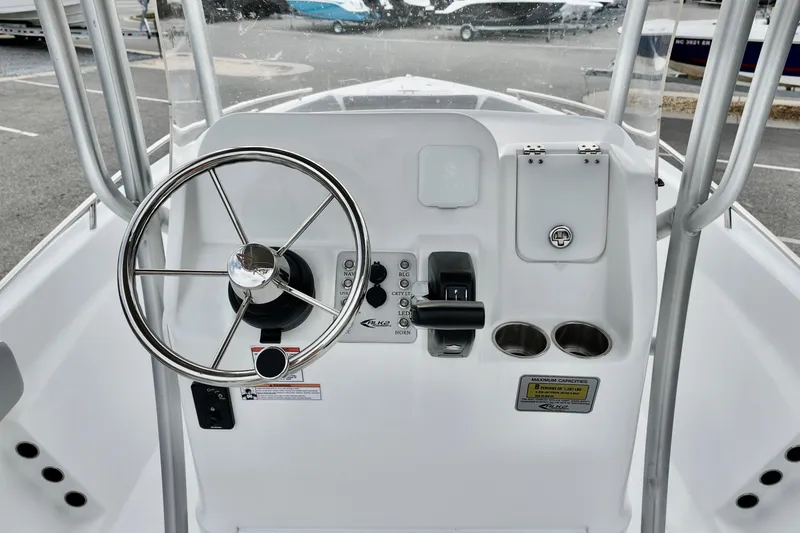 Slide: The Image of Steering console of 2026 ALK2 22CRX boat with controls and cup holders. - 11