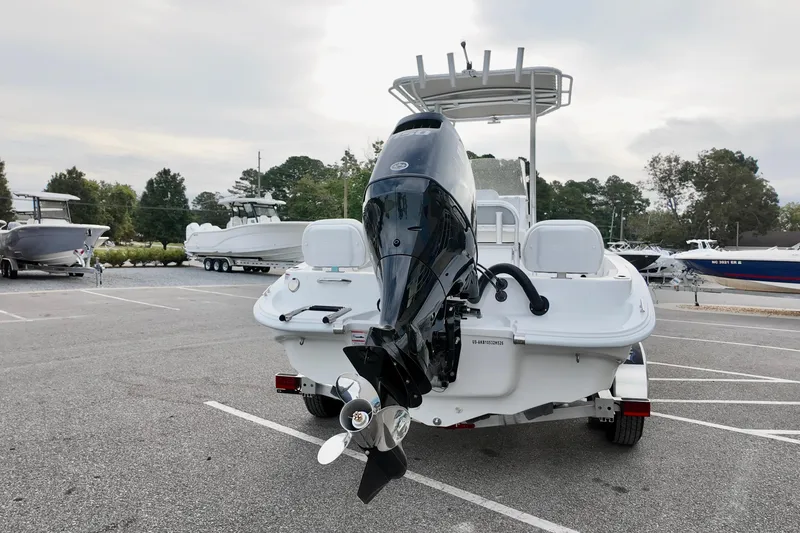 Slide: The Image of 2026 ALK2 22CRX boat with outboard motor in a parking lot. - 4