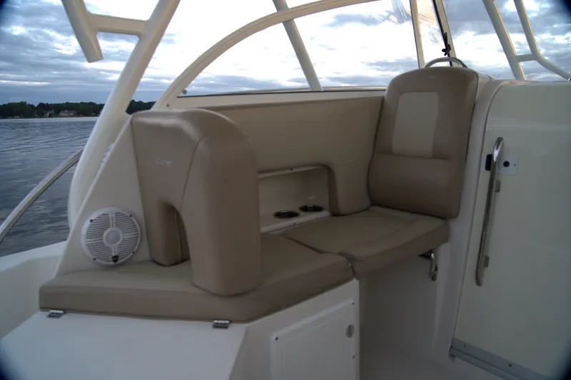Slide: The Image of 2020 Sailfish 270 WAC boat interior with beige seating and cup holders. - 13