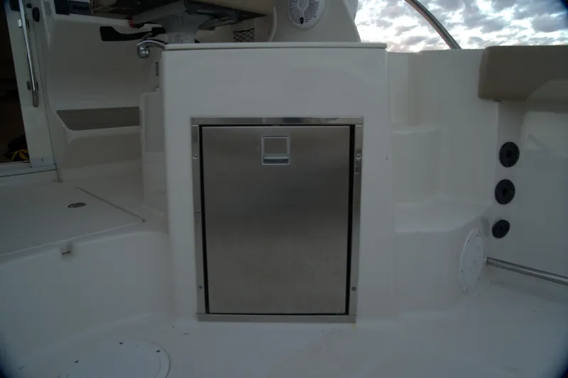 Slide: The Image of 2020 Sailfish 270 WAC boat interior with stainless steel storage compartment. - 18