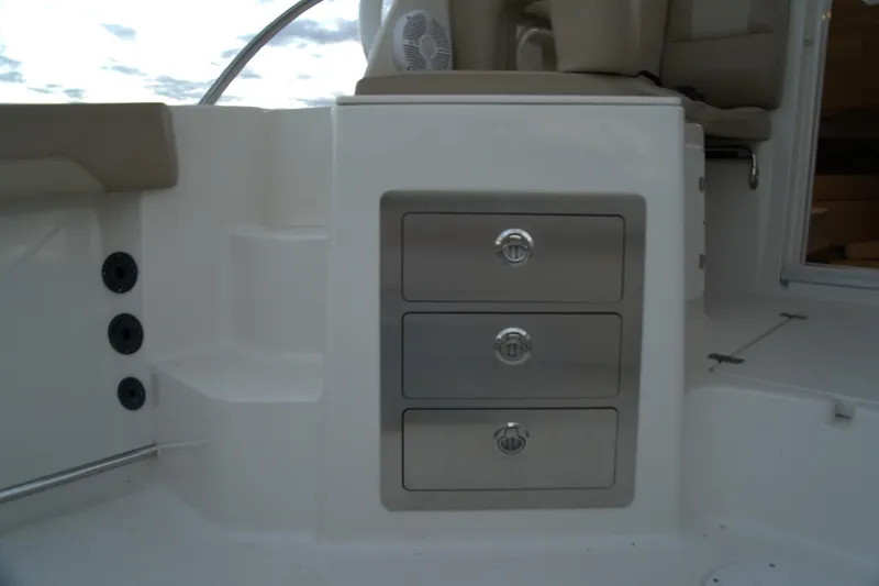 Slide: The Image of 2020 Sailfish 270 WAC boat interior with stainless steel storage drawers. - 19