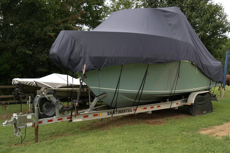 Slide: The Image of Covered 2020 Sailfish 270 WAC boat on trailer, parked on grass. - 31