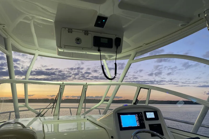 Slide: The Image of Interior view of 2020 Sailfish 270 WAC boat at sunset, featuring navigation equipment. - 4