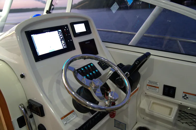 Slide: The Image of 2020 Sailfish 270 WAC boat dashboard with steering wheel and navigation controls. - 5