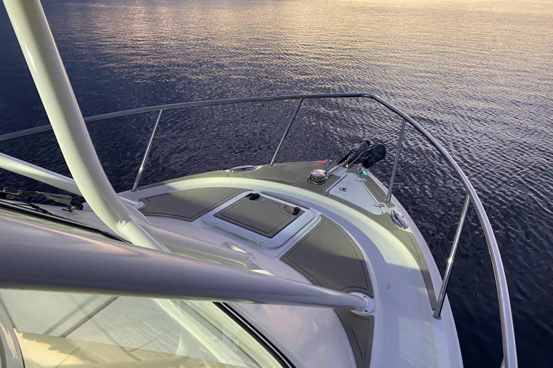 Slide: The Image of 2020 Sailfish 270 WAC boat bow on calm water at sunset. - 8