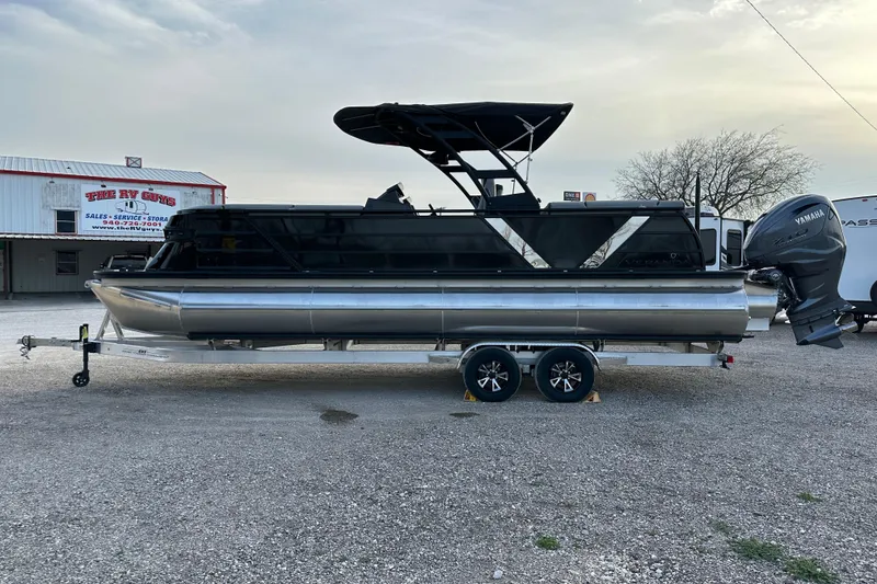 The Image of 2024 Veranda VX 25 DCVL pontoon boat with Yamaha engine on trailer. - 0