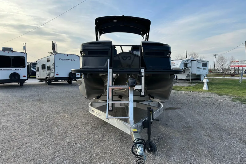 Slide: The Image of 2024 Veranda VX 25 DCVL pontoon boat on trailer, parked near RVs. - 1