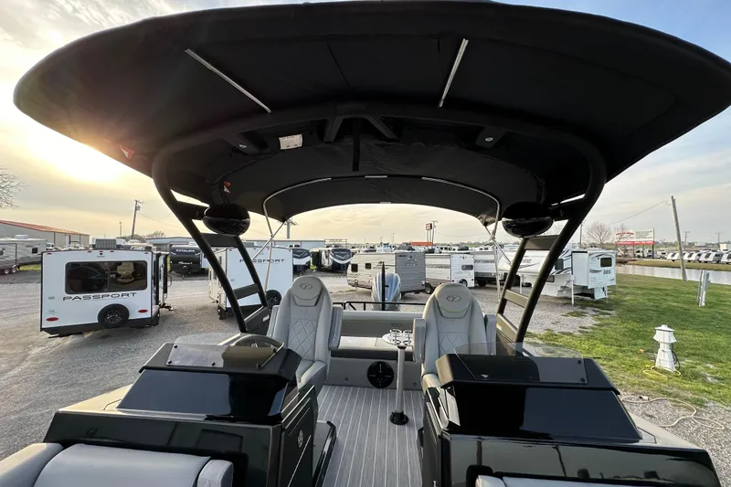 Slide: The Image of 2024 Veranda VX 25 DCVL boat with canopy, parked near RVs and trailers. - 14