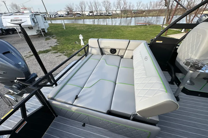 Slide: The Image of 2024 Veranda VX 25 DCVL boat with luxurious seating and sleek design by a lakeside. - 20