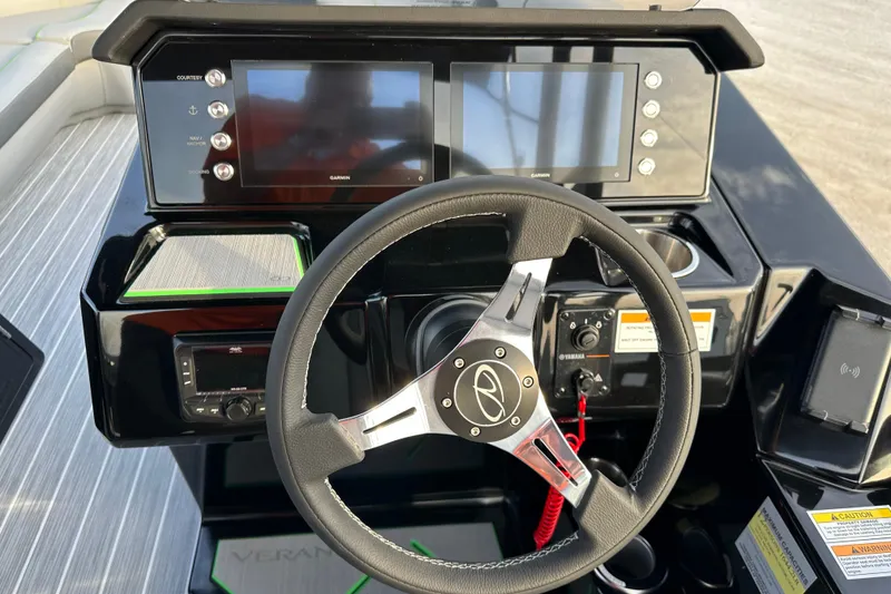 Slide: The Image of 2024 Veranda VX 25 DCVL boat dashboard with steering wheel and digital displays. - 21
