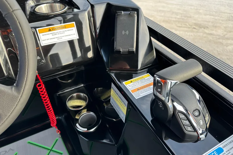 Slide: The Image of 2024 Veranda VX 25 DCVL boat console with controls and warning labels. - 22