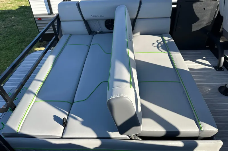 Slide: The Image of 2024 Veranda VX 25 DCVL boat interior with gray seating and green accents. - 33