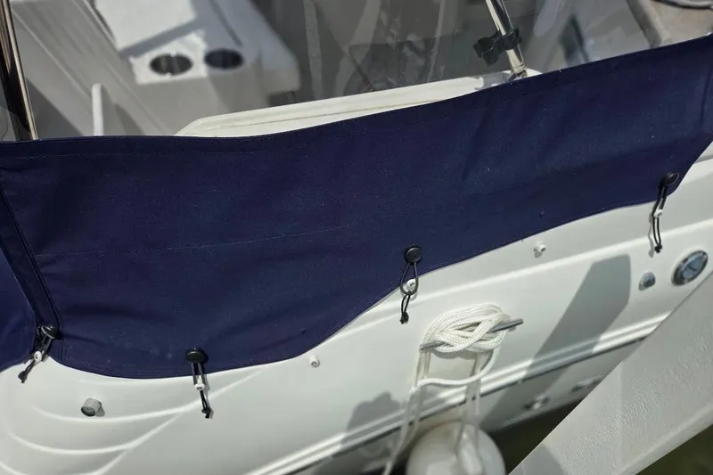 Slide: The Image of 2007 Rinker 320 Express Cruiser with navy blue cover and white hull detailing. - 11