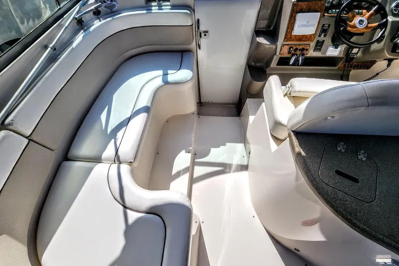 Slide: The Image of 2007 Rinker 320 Express Cruiser interior with seating and helm area. - 13