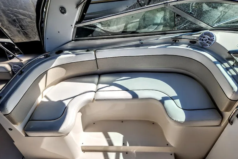 Slide: The Image of 2007 Rinker 320 Express Cruiser interior seating with curved design and speaker. - 14