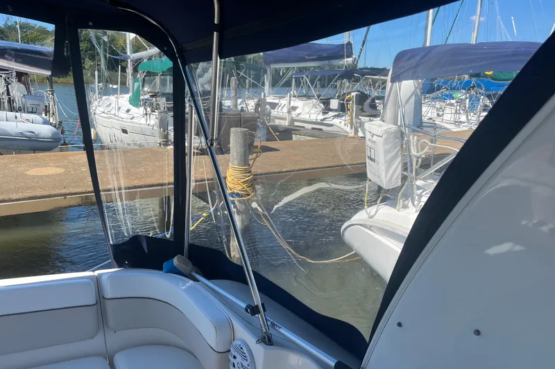 Slide: The Image of 2007 Rinker 320 Express Cruiser interior view at marina with docked boats. - 17