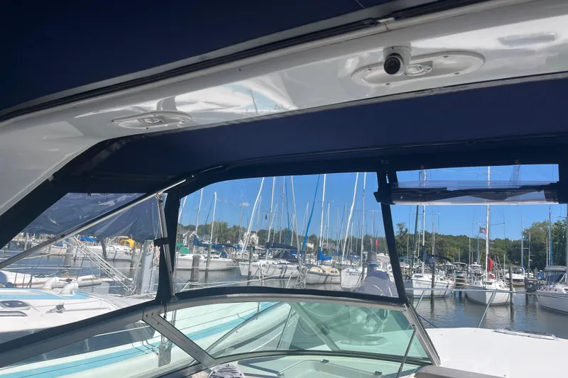 Slide: The Image of 2007 Rinker 320 Express Cruiser interior view with marina backdrop. - 18