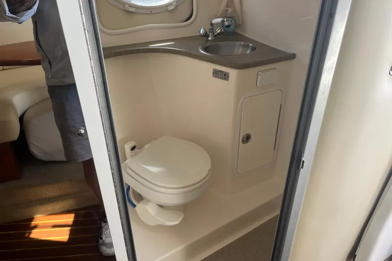Slide: The Image of 2007 Rinker 320 Express Cruiser bathroom with sink and toilet. - 25