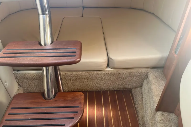 Slide: The Image of Interior of 2007 Rinker 320 Express Cruiser with wooden steps and cushioned seating area. - 26