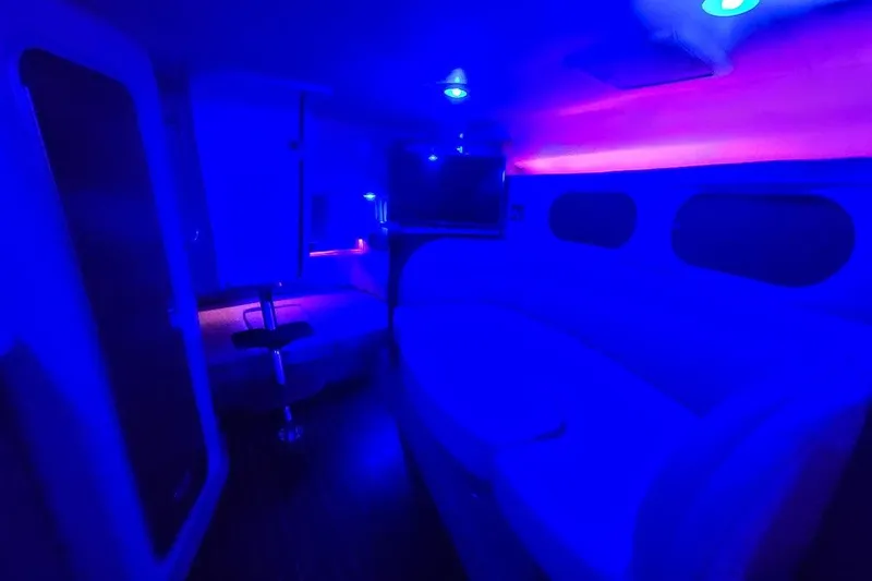 Slide: The Image of Interior of 2007 Rinker 320 Express Cruiser with blue ambient lighting. - 28