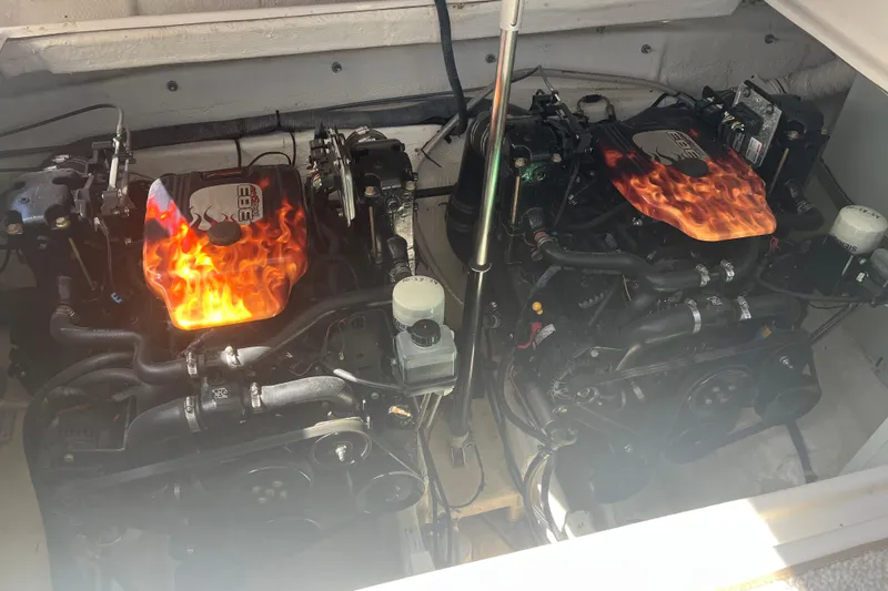 Slide: The Image of 2007 Rinker 320 Express Cruiser engine compartment with custom flame-painted covers. - 31