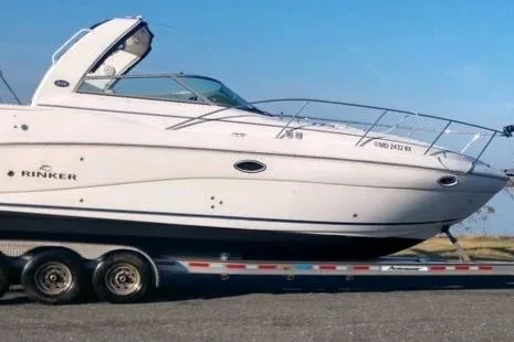 Slide: The Image of 2007 Rinker 320 Express Cruiser on trailer, side view, clear sky background. - 32
